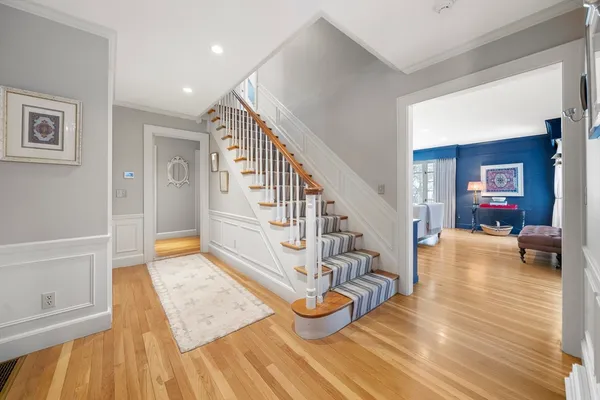 a view of entryway livingroom and hall with wooden floor