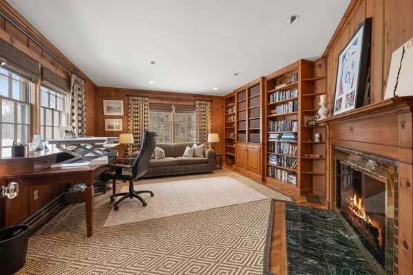a living room with furniture a rug and a fireplace