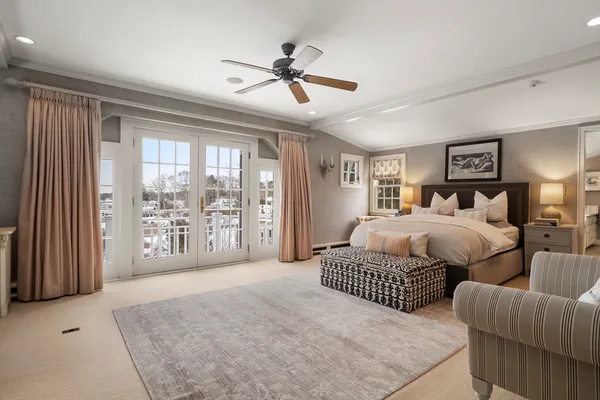 a bedroom with a large bed and a large window