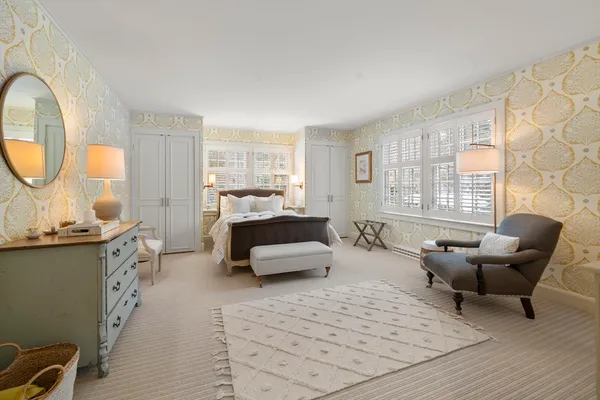 a bedroom with furniture and a large window
