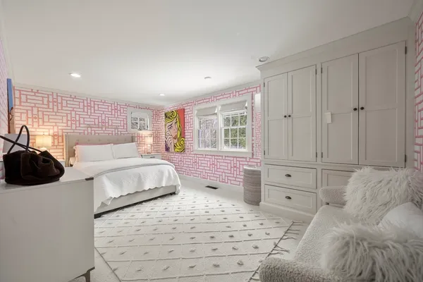 a bedroom with a large bed and a window