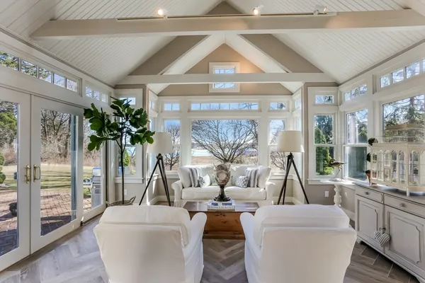 a living room with furniture a large window and a table