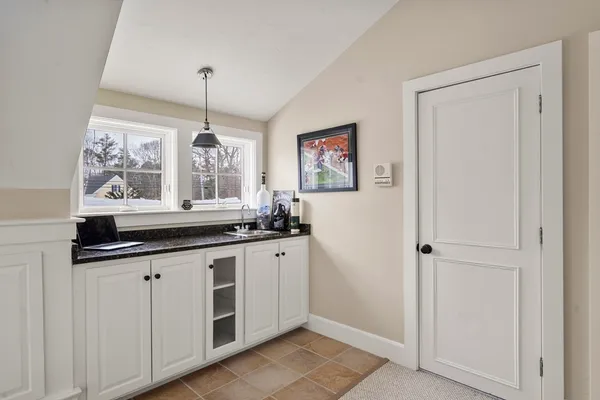 a kitchen with stainless steel appliances granite countertop a dishwasher a stove a dining table and chairs