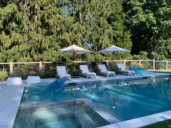 a view of a patio with chairs and a yard