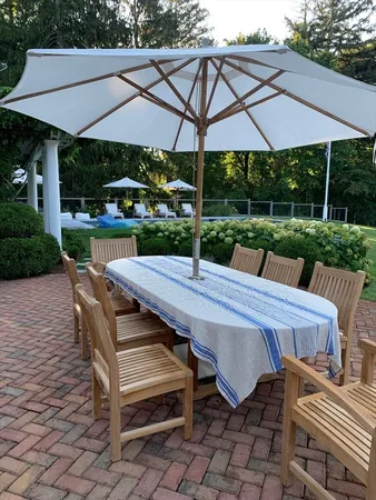 a view of a patio with table and chairs under an umbrella