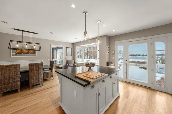 a large kitchen with kitchen island granite countertop a large center island and a wooden floor