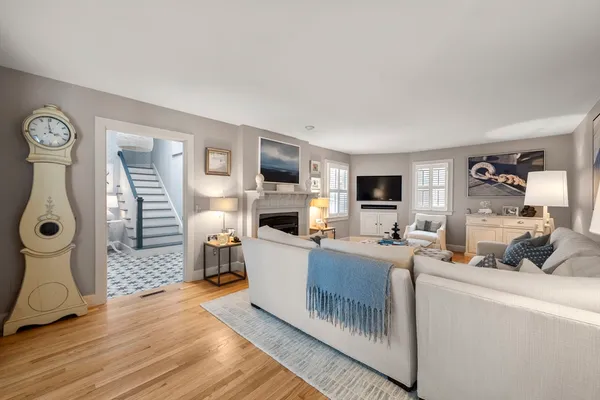 a living room with furniture a flat screen tv and a fireplace
