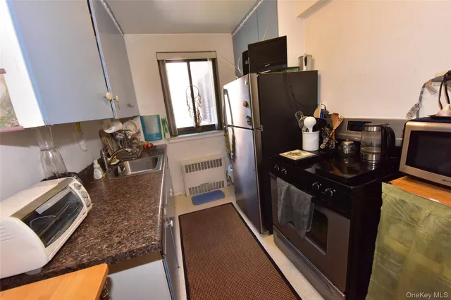 a kitchen with stainless steel appliances granite countertop a refrigerator stove and sink