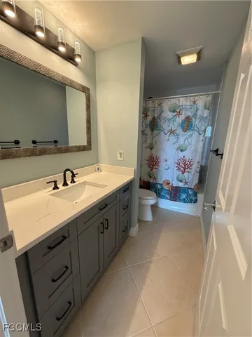 a bathroom with a toilet a sink and a mirror