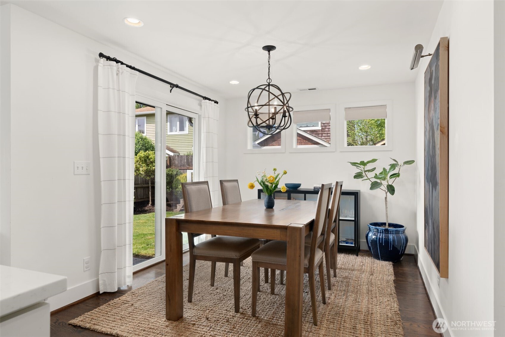 4129 19th Avenue Southwest Seattle, WA 98106 - Photo 15 of 34 a view of a dining room with furniture wooden floor and a chandelier