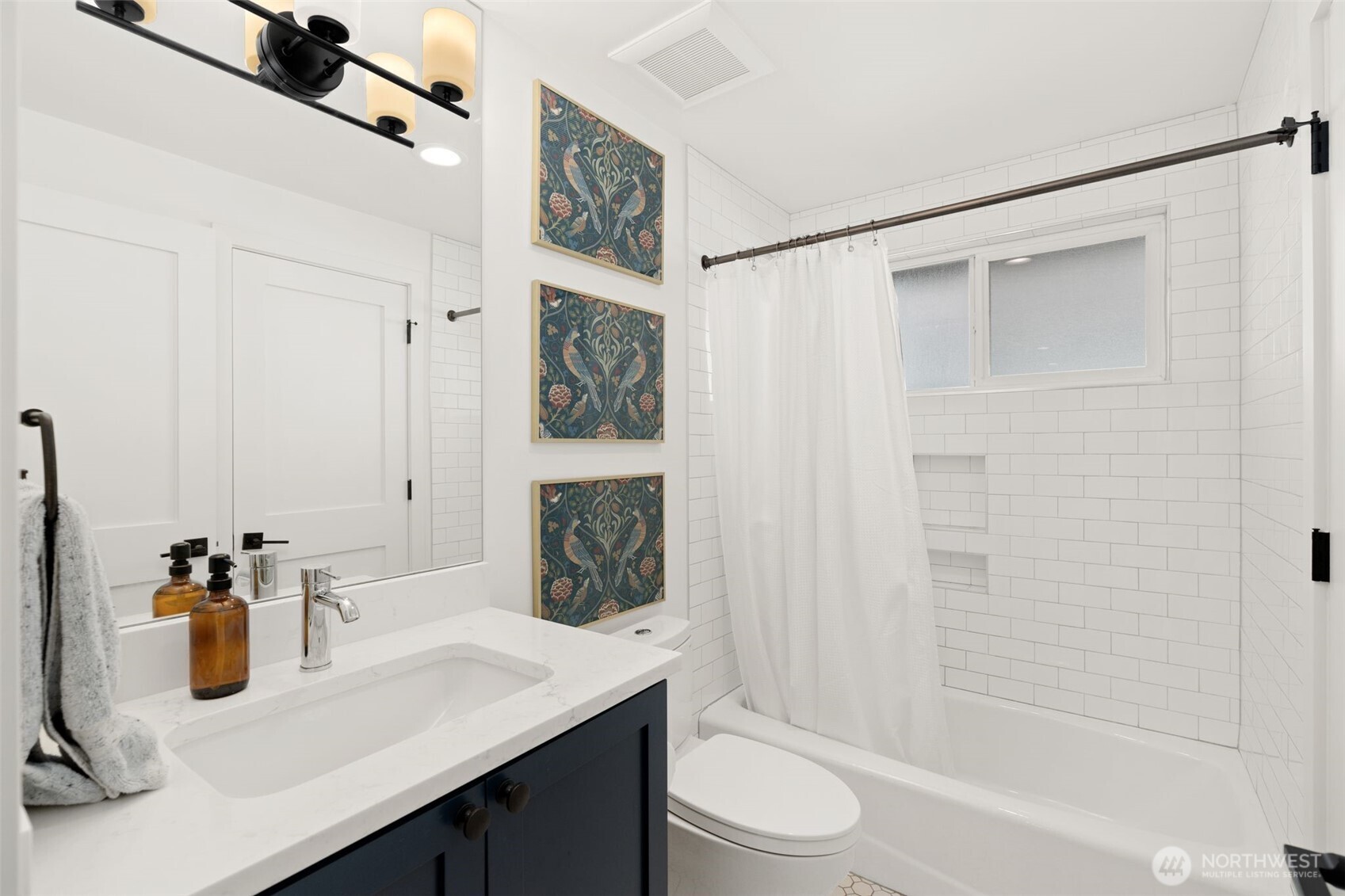4129 19th Avenue Southwest Seattle, WA 98106 - Photo 21 of 34 a bathroom with a sink a toilet and shower