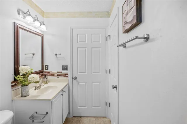 a bathroom with a sink a toilet and mirror