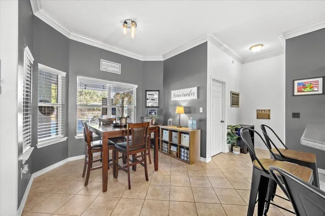 a view of a dining room with furniture and a large window
