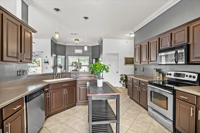 a kitchen with stainless steel appliances granite countertop a sink stove and cabinets