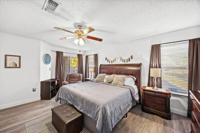 a bedroom with a bed and wooden floor