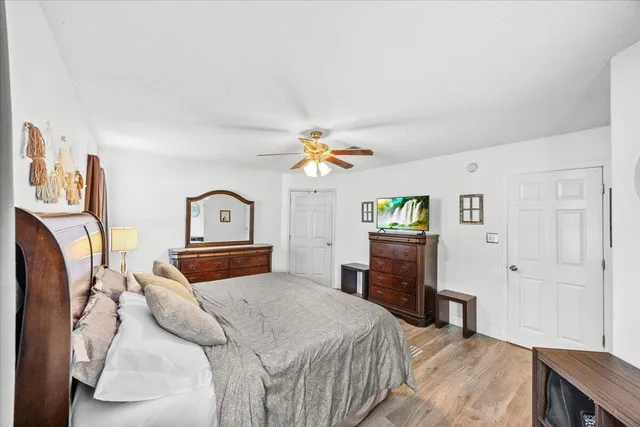 a bedroom with a bed dresser and a window