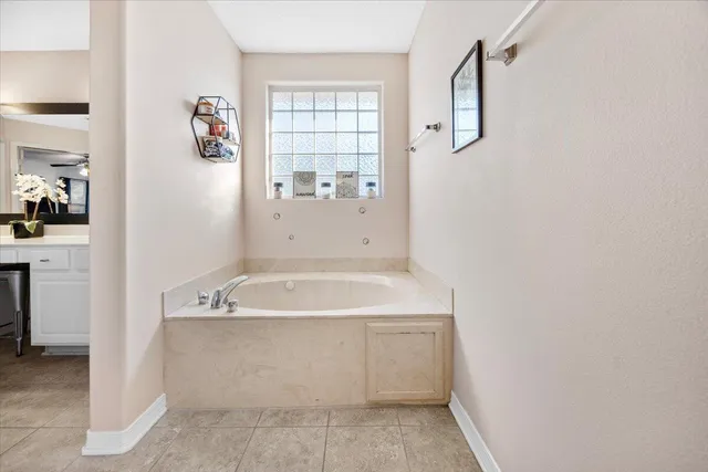 a spacious bathroom with a bathtub and shower