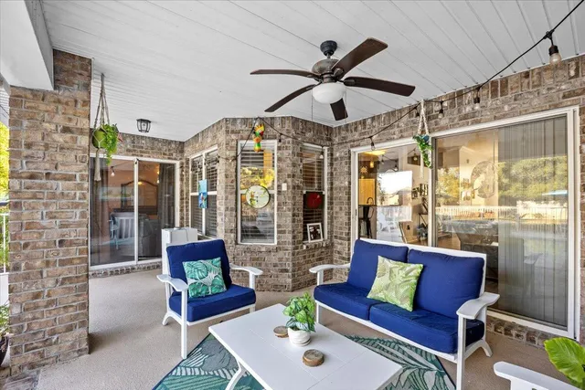 a living room with furniture and a ceiling fan
