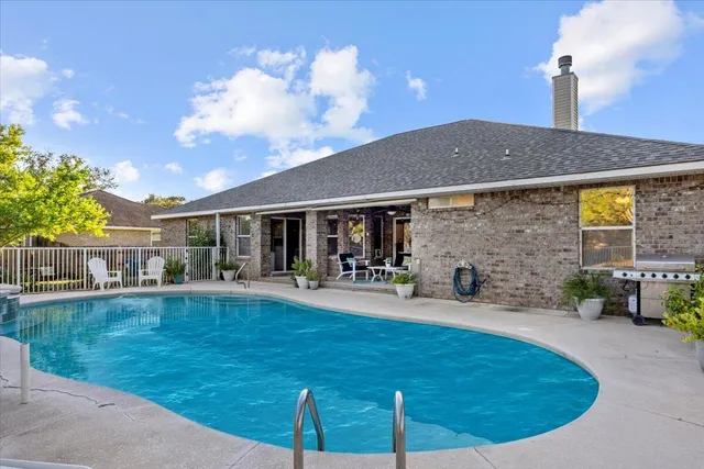 a view of house with yard outdoor seating area and barbeque oven