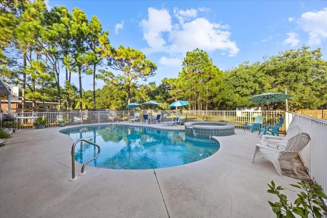 a view of a swimming pool with a patio and garden