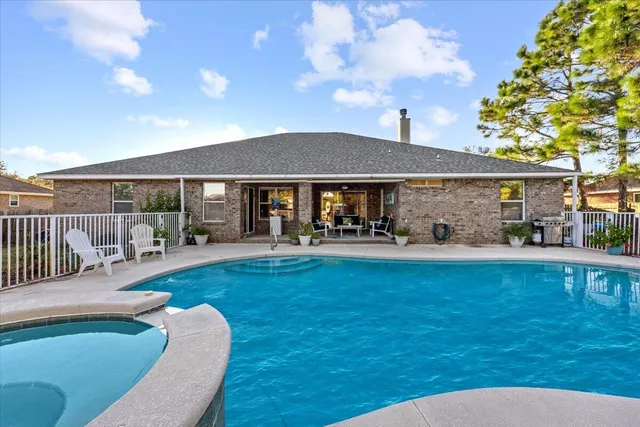 a view of a house with pool porch and furniture