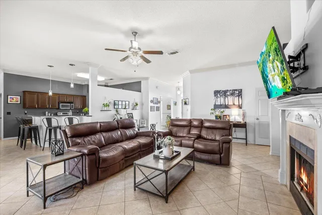 a living room with furniture a fireplace and a flat screen tv