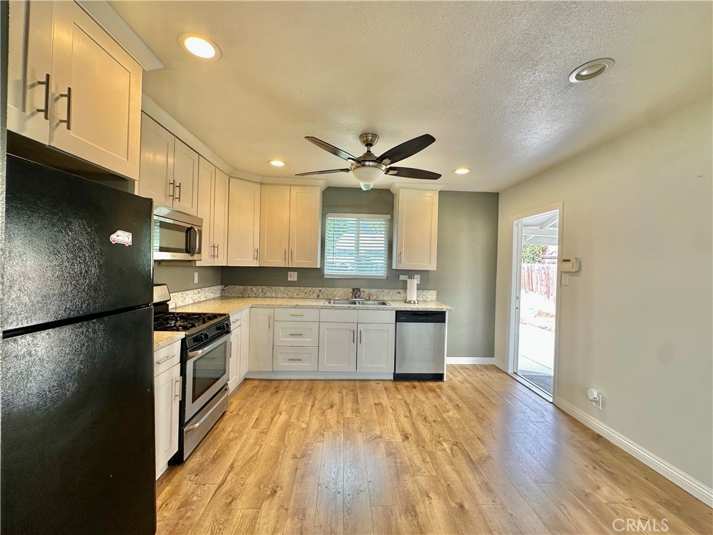 441 Hurstview Avenue Monrovia, CA 91016 - Photo 12 of 16 a kitchen with granite countertop a stove top oven a sink dishwasher and a refrigerator with wooden floor