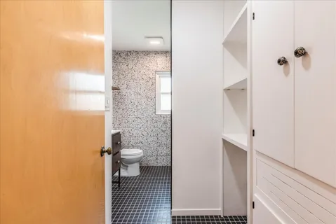 a bathroom with a granite countertop sink