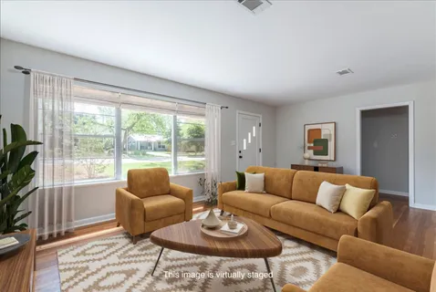 a living room with furniture and a large window