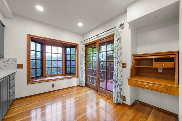a bedroom with furniture and large window