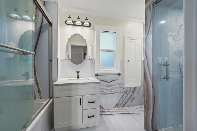 a bathroom with a sink double vanity and a mirror