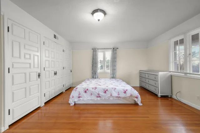 a bedroom with bed and window