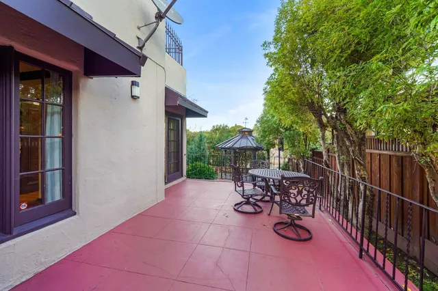 a view of a patio with table and chairs and potted plants