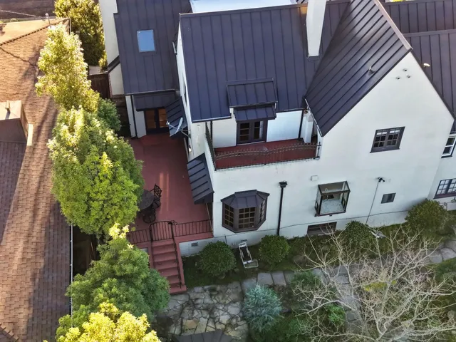 a aerial view of a house with a yard and potted plants