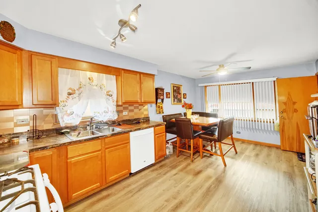 a large kitchen with lots of counter top space and wooden floor