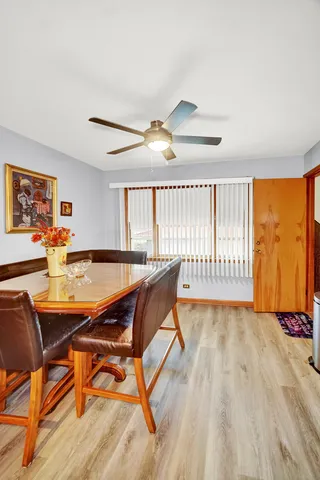 a dining room with furniture and a floor to ceiling window