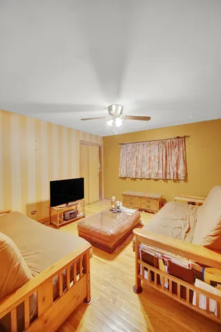 a bedroom with furniture and flat screen tv