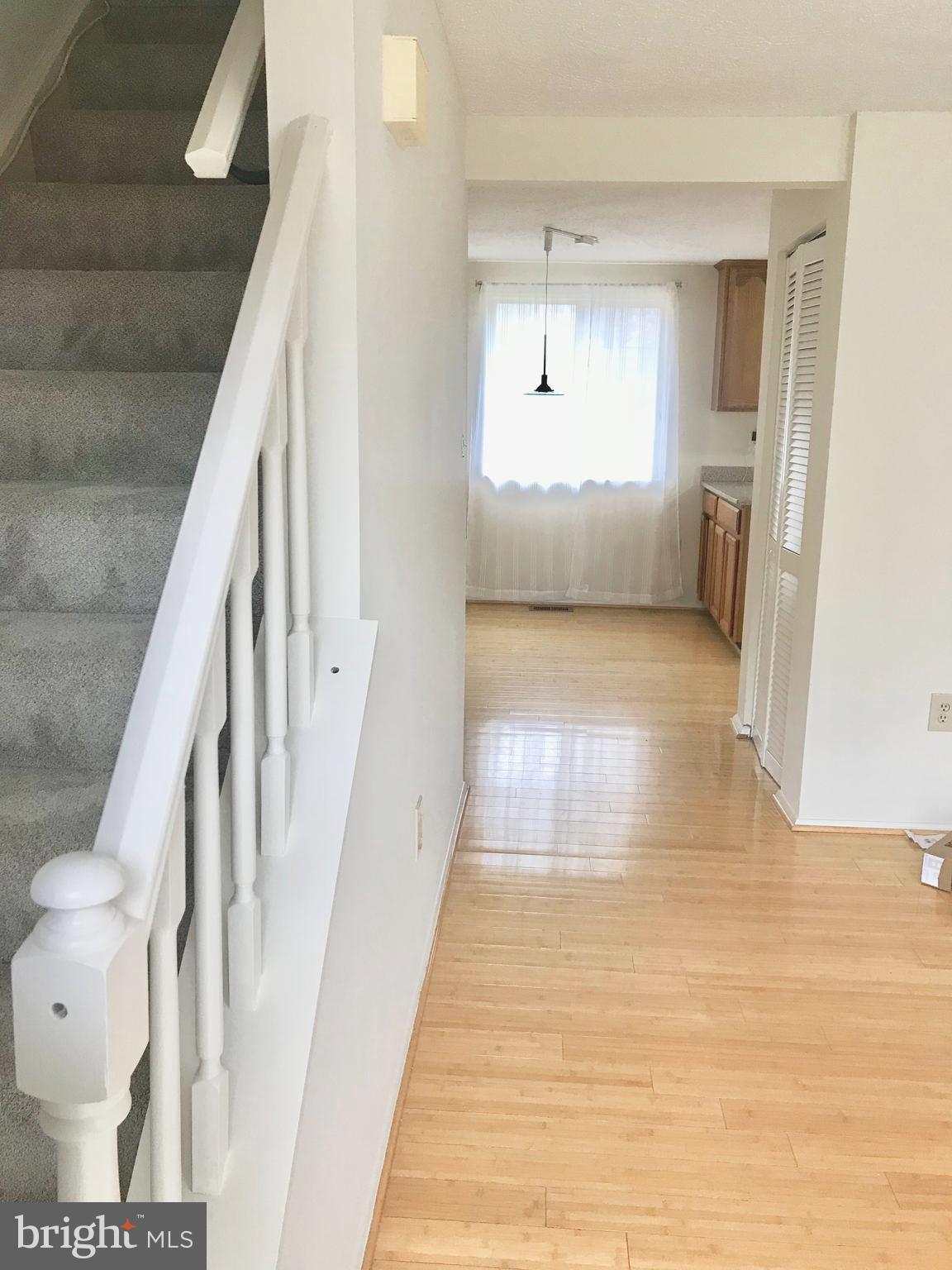 6214 Hillside Road Springfield, VA 22152 - Photo 2 of 22 a view of hallway with wooden floor and stairs