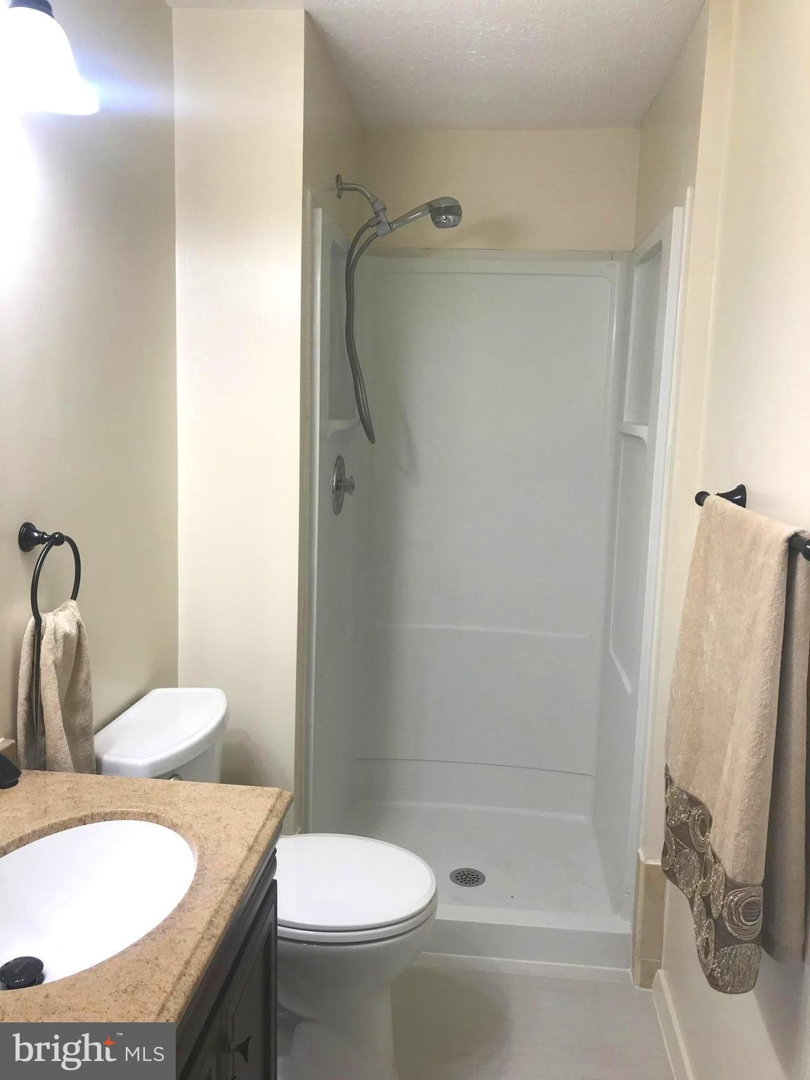 6214 Hillside Road Springfield, VA 22152 - Photo 11 of 22 a bathroom with a sink toilet and shower