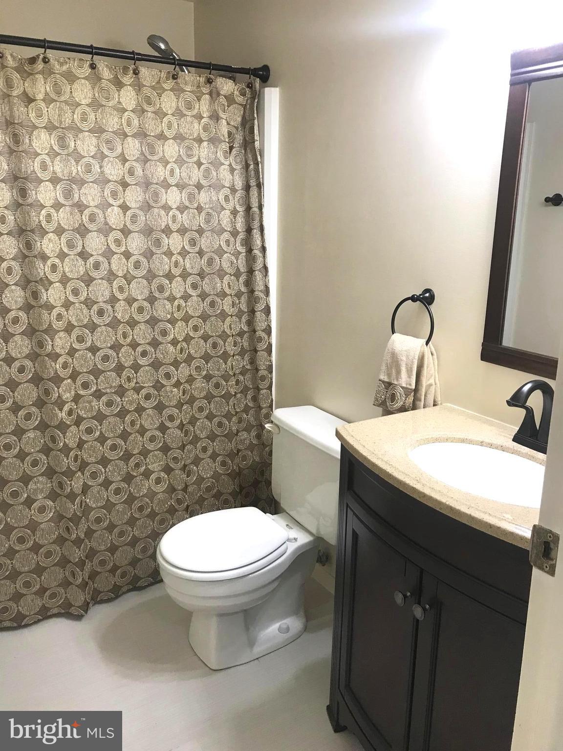 6214 Hillside Road Springfield, VA 22152 - Photo 16 of 22 a bathroom with a granite countertop toilet and a sink
