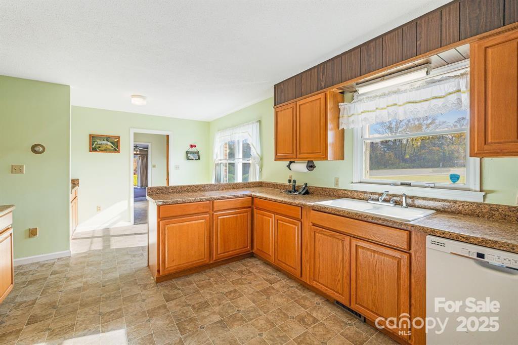 7 Brookshire Road Leicester, NC 28748 - Photo 11 of 40 a kitchen with stainless steel appliances granite countertop a stove a sink and a refrigerator