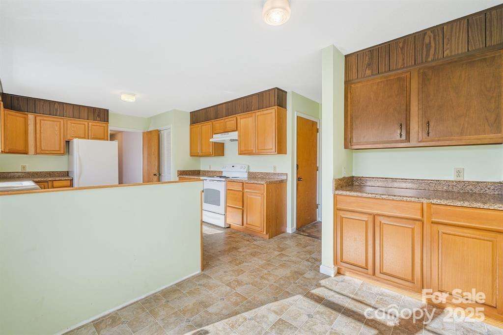 7 Brookshire Road Leicester, NC 28748 - Photo 12 of 40 a kitchen with refrigerator and cabinets