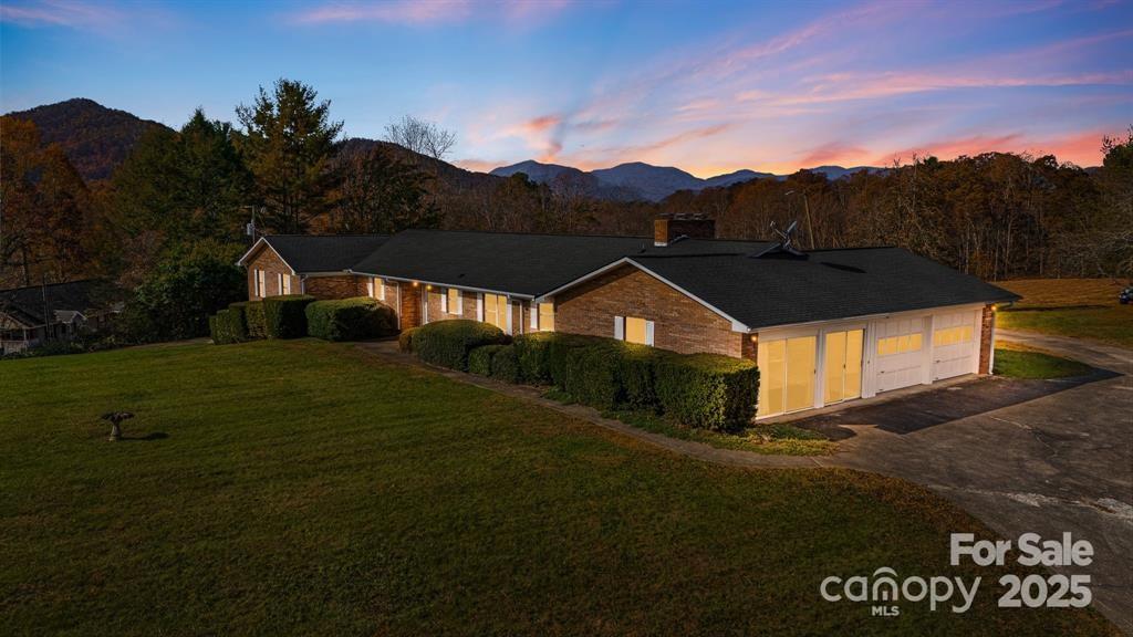 7 Brookshire Road Leicester, NC 28748 - Photo 38 of 40 a front view of a house with a yard and garage