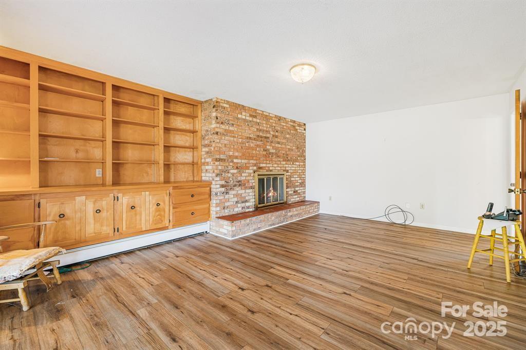 7 Brookshire Road Leicester, NC 28748 - Photo 6 of 40 a view of an empty room with wooden floor and a window