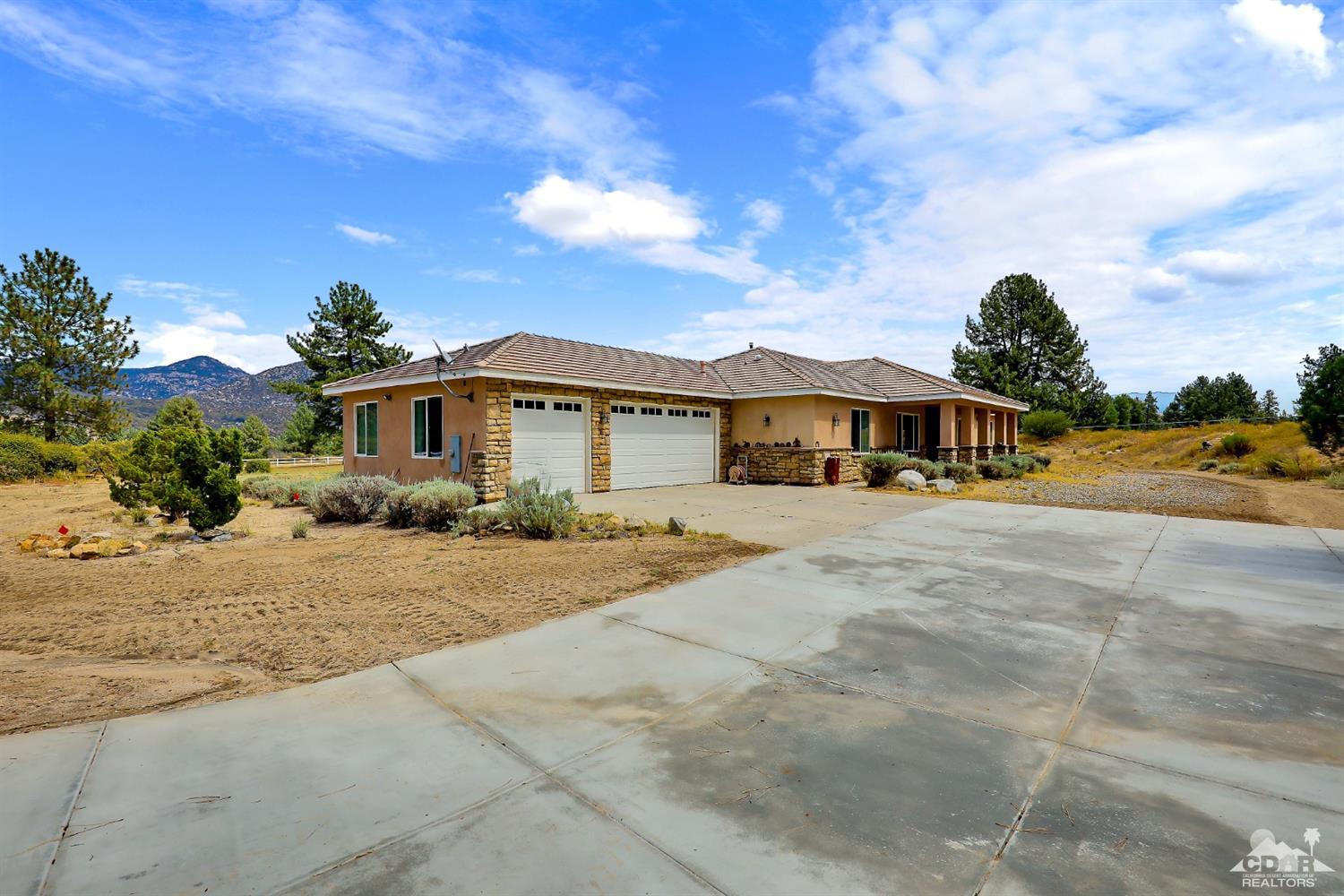 59870 Devils Ladder Road Mountain Center, CA 92561 - Photo 2 of 31 a front view of a house with a yard