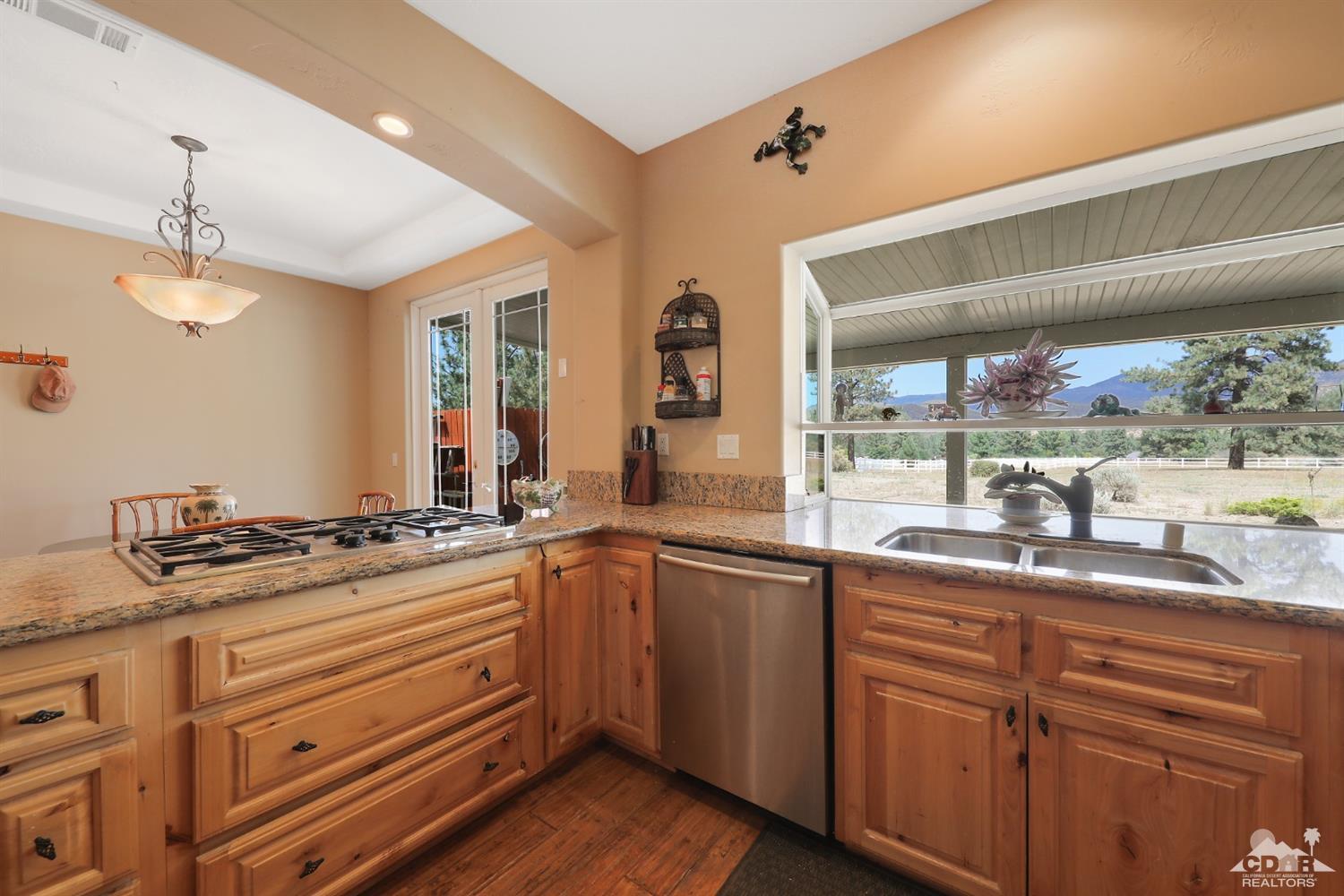 59870 Devils Ladder Road Mountain Center, CA 92561 - Photo 14 of 31 a kitchen with granite countertop stainless steel appliances a sink and cabinets