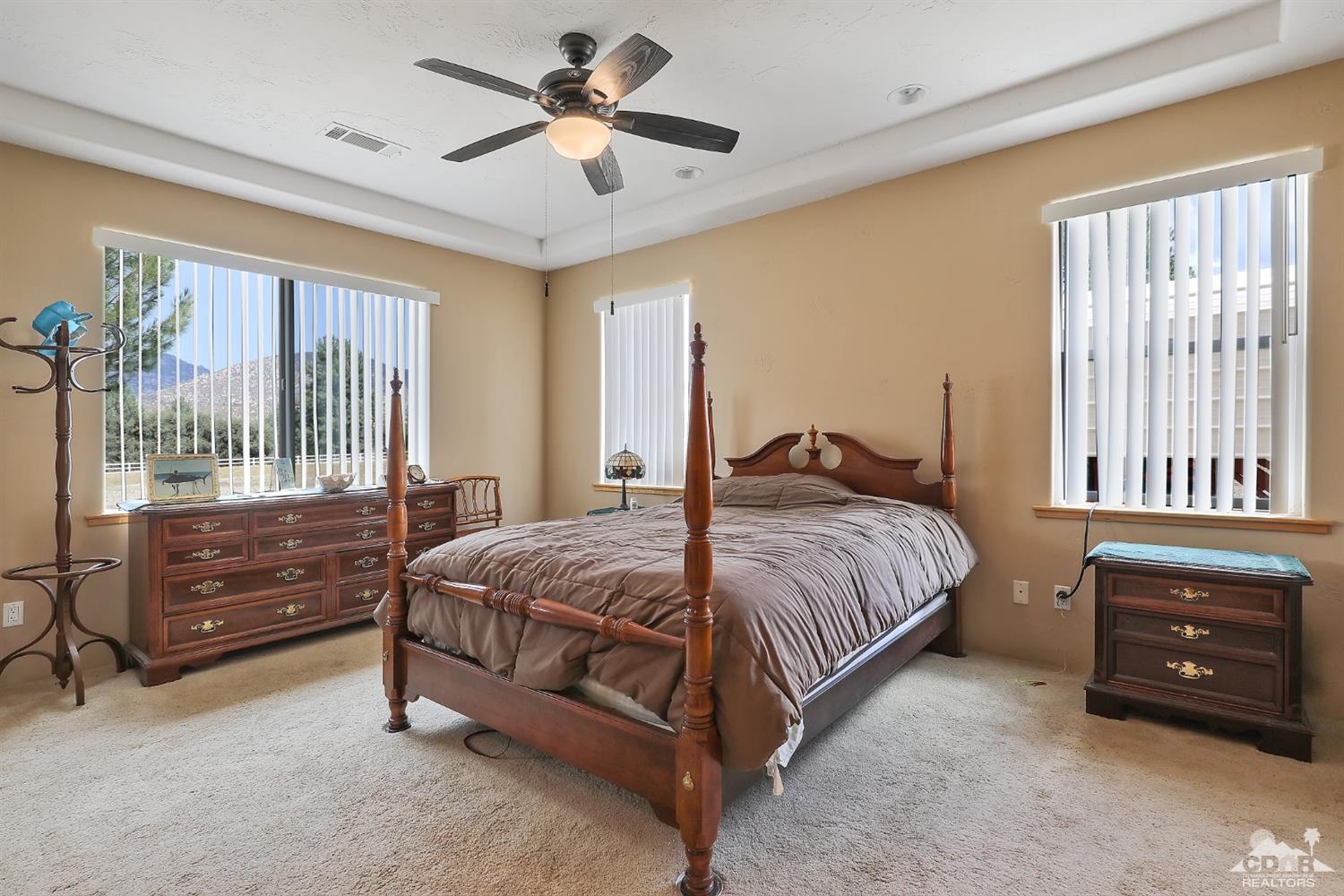 59870 Devils Ladder Road Mountain Center, CA 92561 - Photo 20 of 31 a bedroom with a bed a dresser and a window