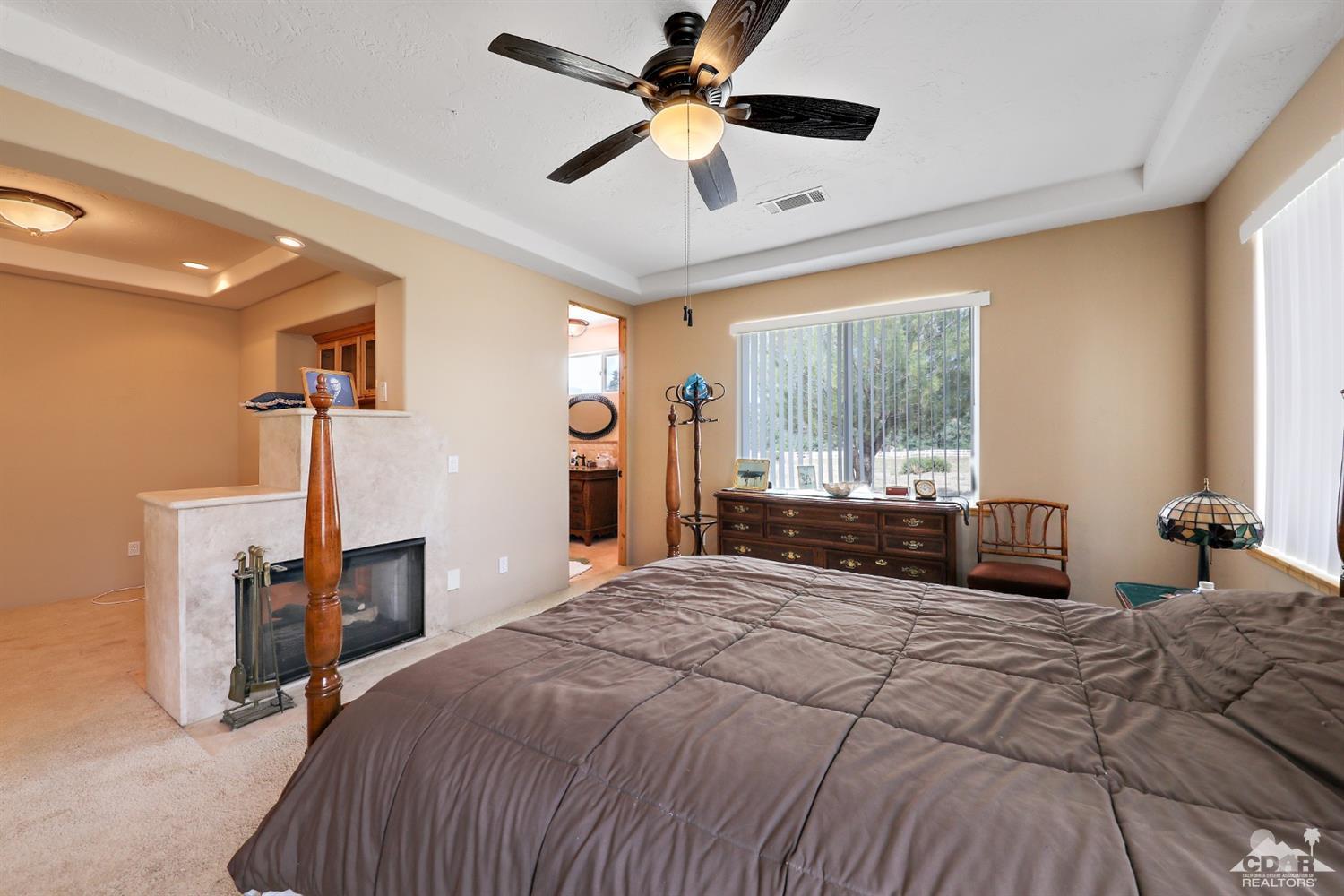 59870 Devils Ladder Road Mountain Center, CA 92561 - Photo 22 of 31 a bedroom with a large bed and a large window