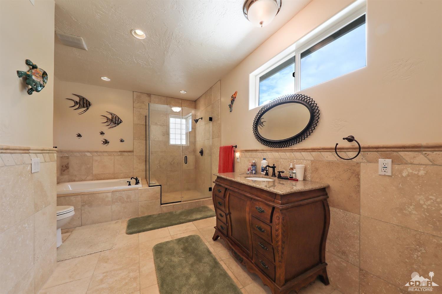 59870 Devils Ladder Road Mountain Center, CA 92561 - Photo 23 of 31 a bathroom with a sink mirror vanity and a bathtub