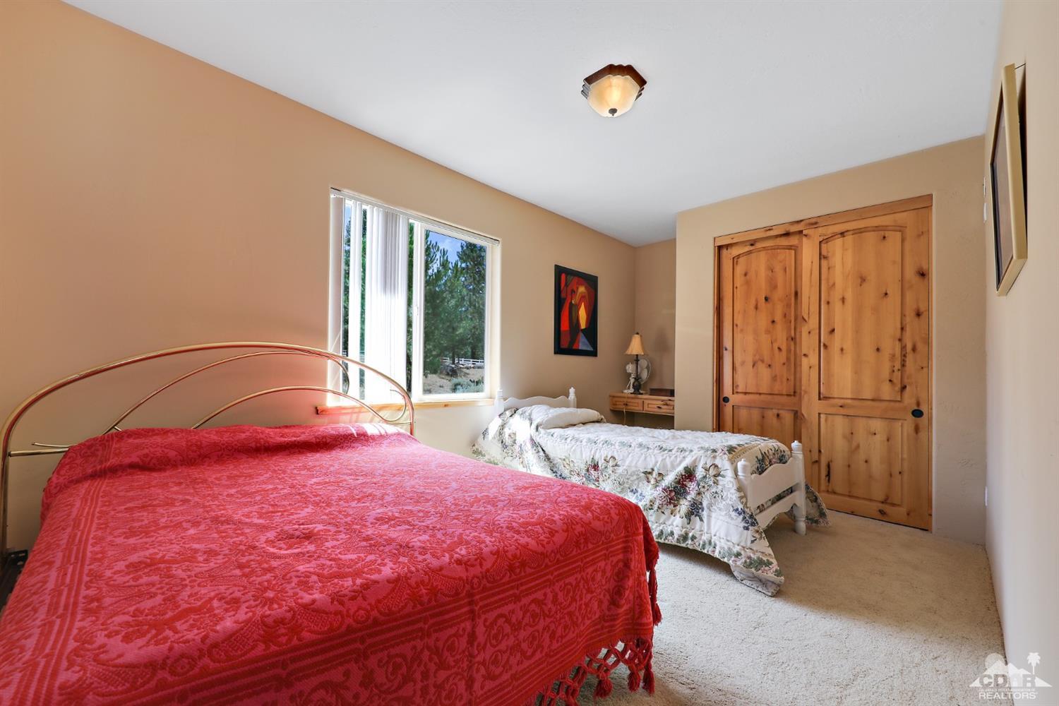 59870 Devils Ladder Road Mountain Center, CA 92561 - Photo 24 of 31 a bedroom with a large bed and a window